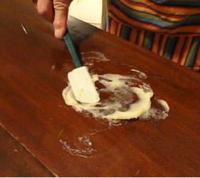 scrubbing with toothbrush to remote white spots from table
